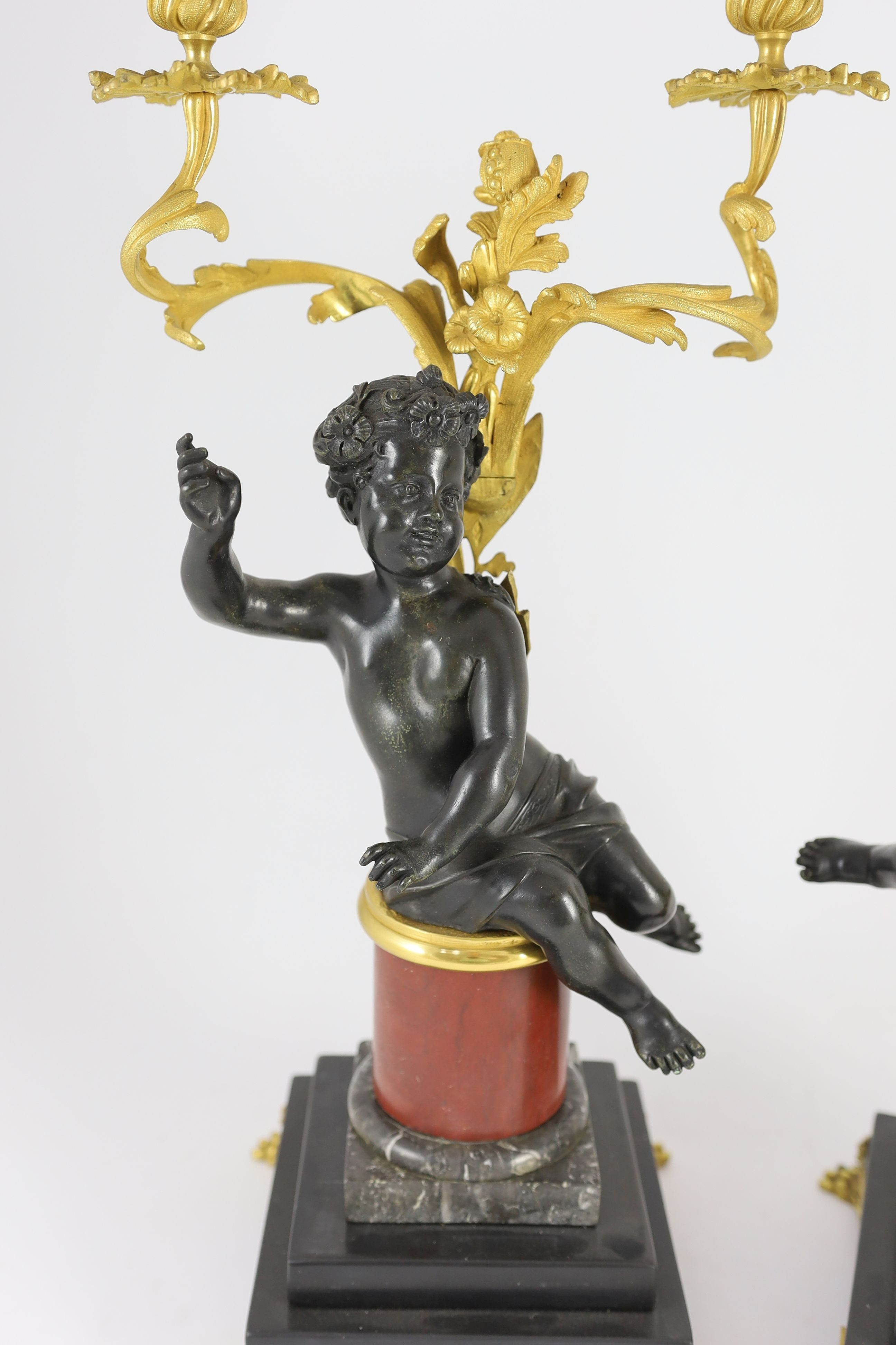 A pair of Louis XVI style bronze and ormolu two light candelabra, 22cm wide, 51cm high